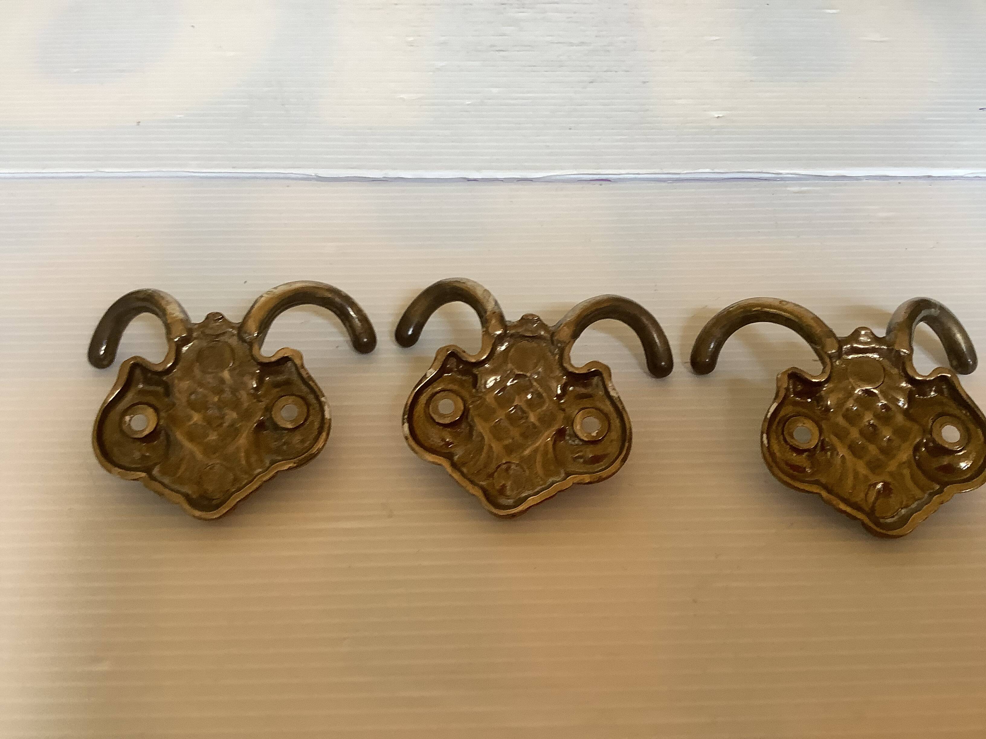 Three double brass coat hooks.