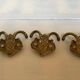 Three double brass coat hooks.