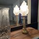 Table lamp with brass base and vintage flame globe