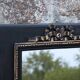 Vintage black and gold wooden mirror with a pediment – Napoléon III style