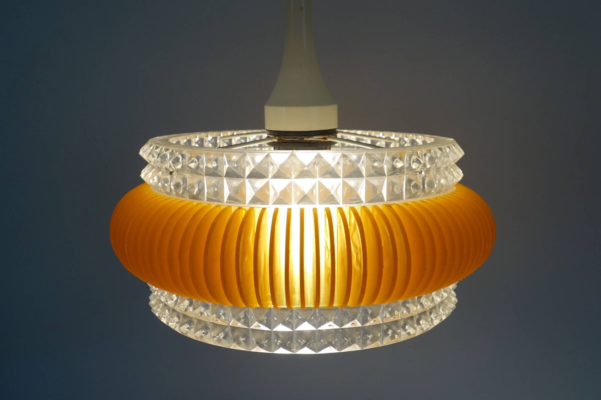 Transparent plastic space age lustre with orange band from the 70s.