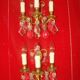 Pair of bronze and crystal wall lights with three candle holders from the early 20th century.