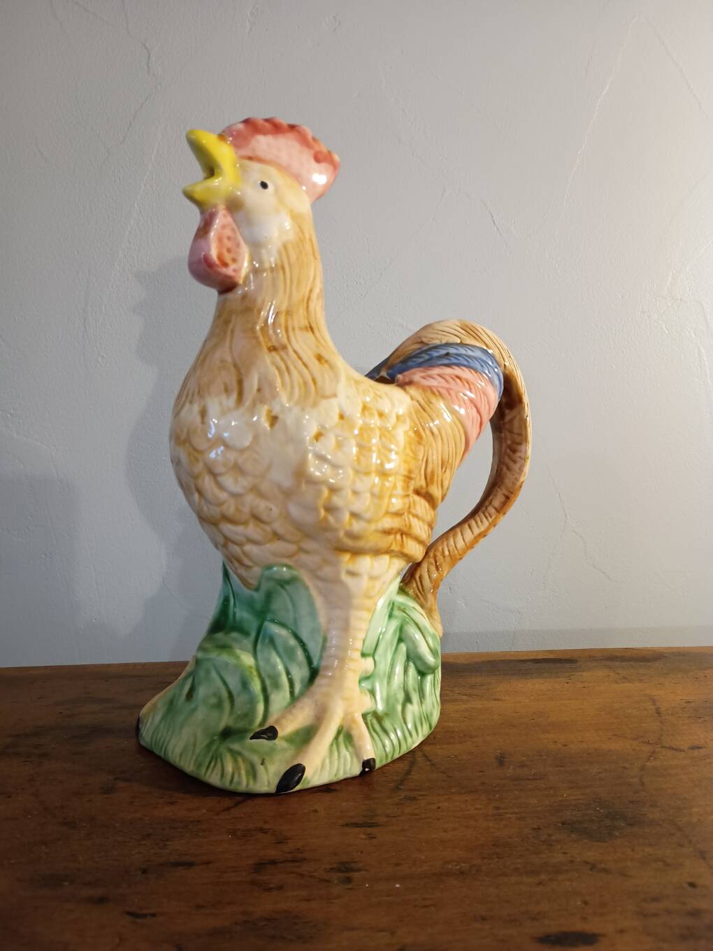 Vintage slipware jug in the shape of a rooster.