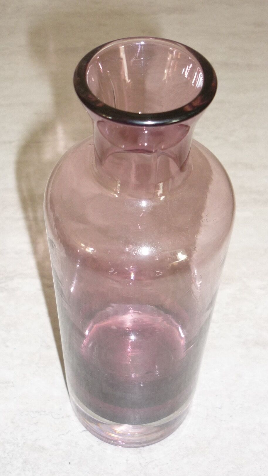 Plum-colored glass bottle with bubble
