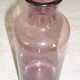 Plum-colored glass bottle with bubble