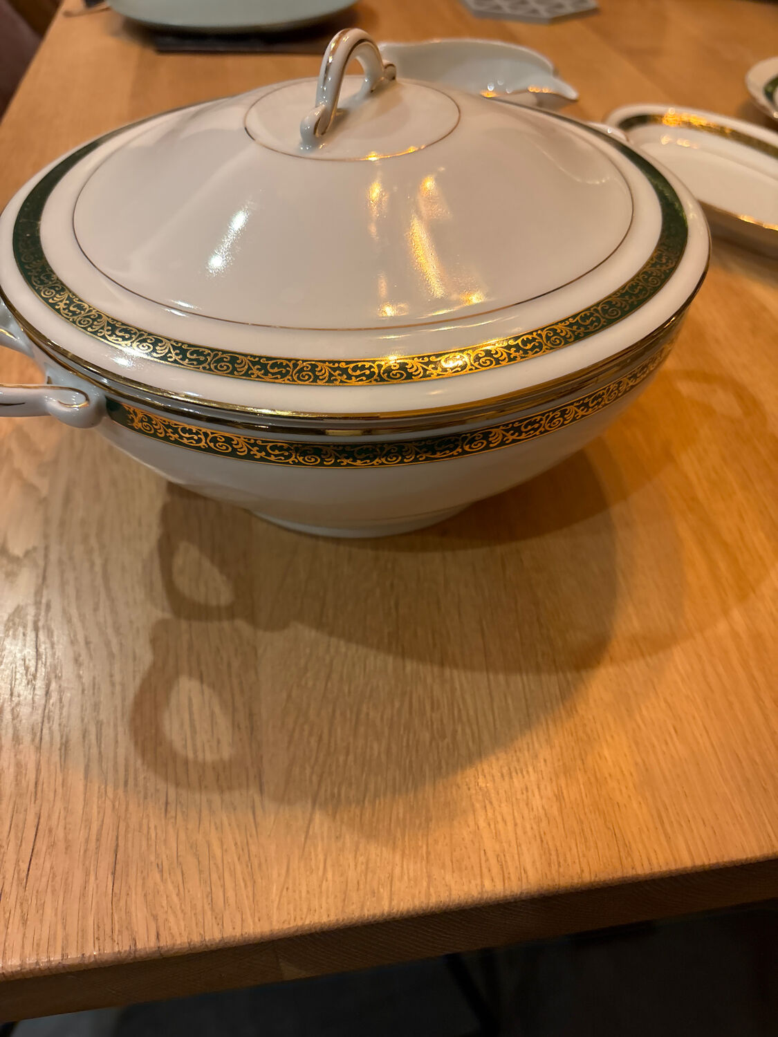 Complete old service in green and gold Limoges porcelain.