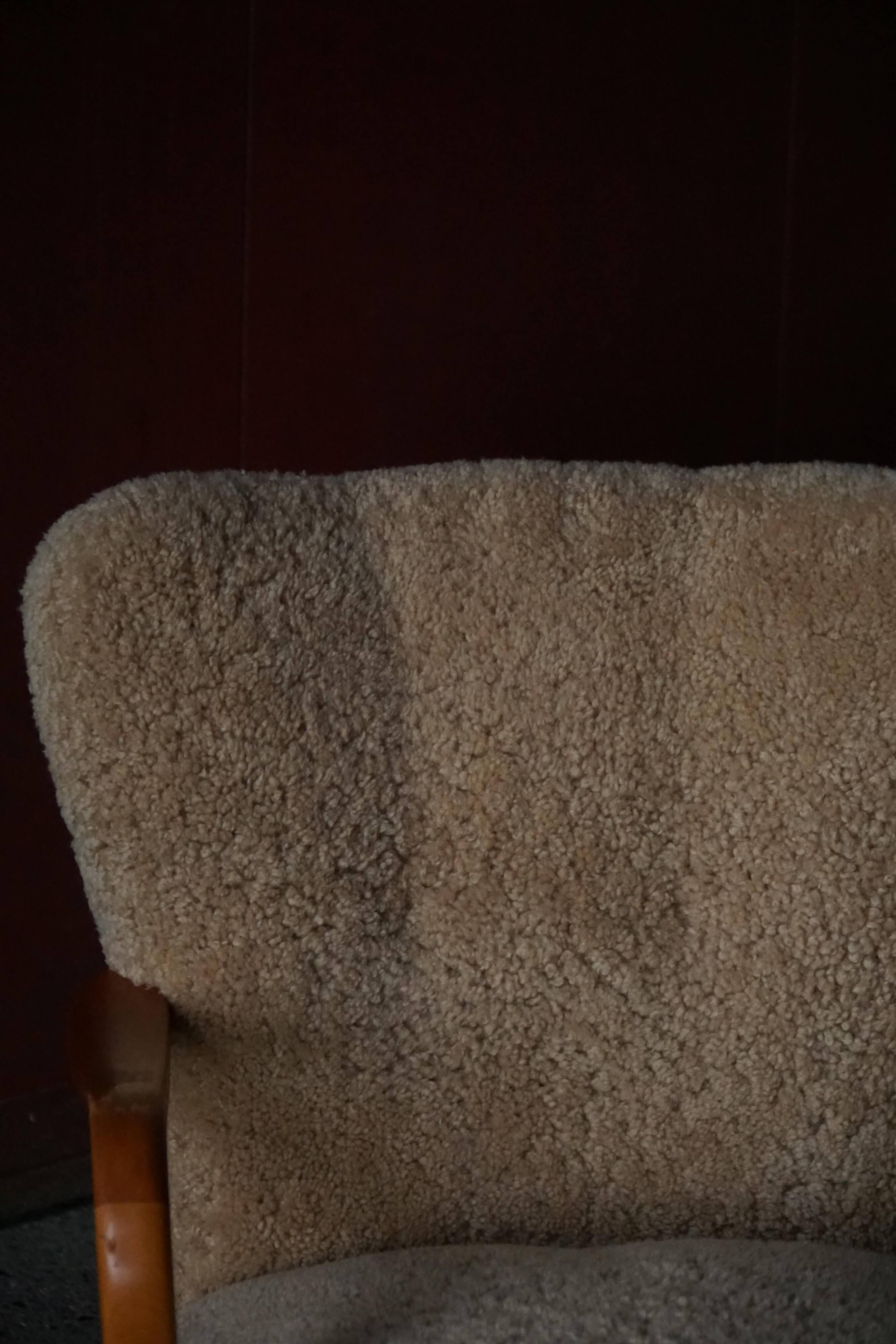 Pair of Mid Century Modern Swedish lounge chairs in birch and lamb's wool, 1960s.