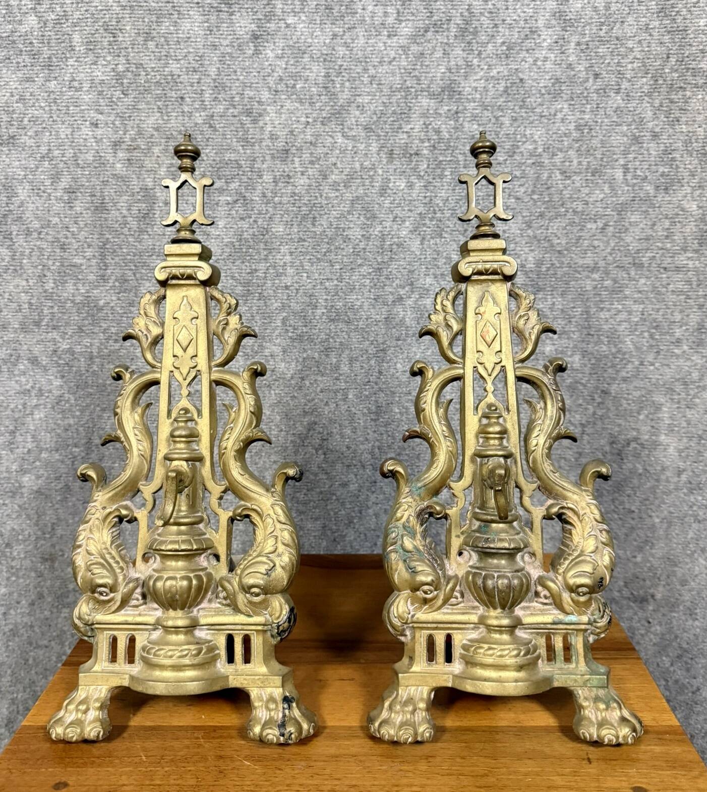 pair of Empire period dolphin firedogs in gilded bronze