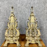 pair of Empire period dolphin firedogs in gilded bronze