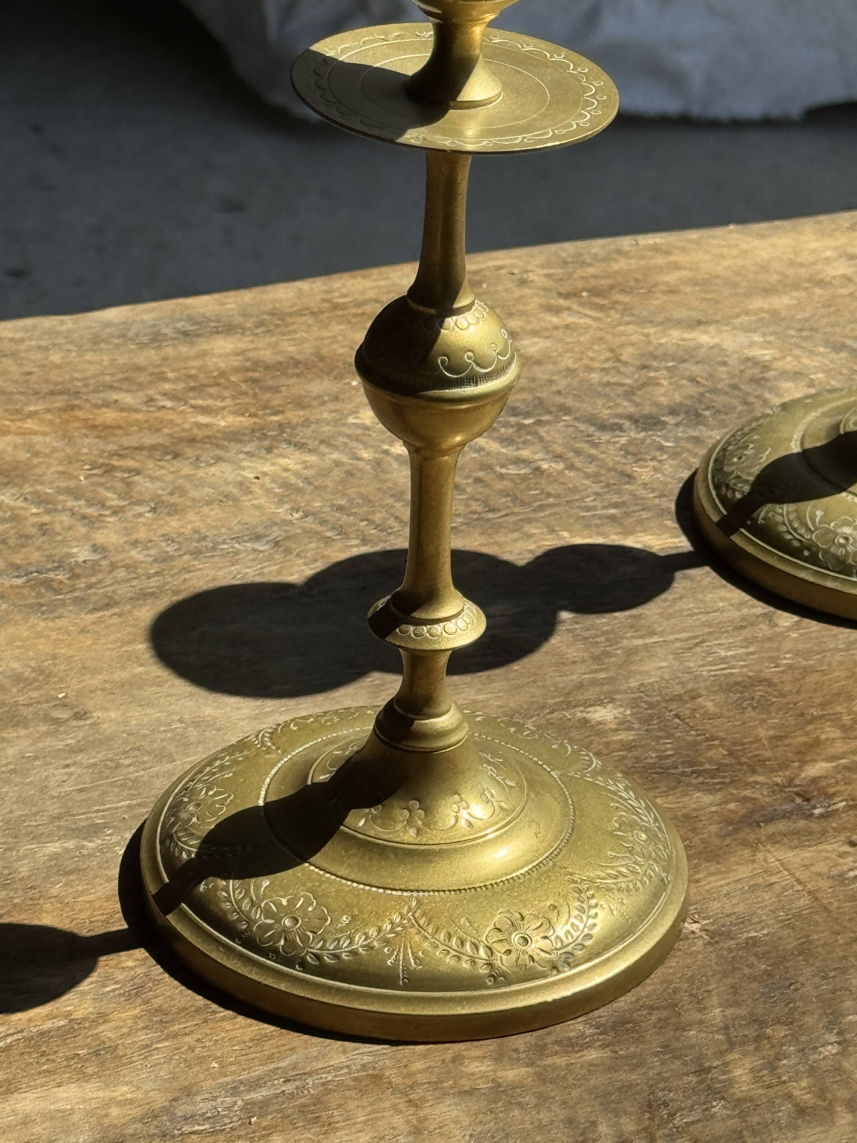 Pair of gilded candlesticks with engraved flower garland motifs H22