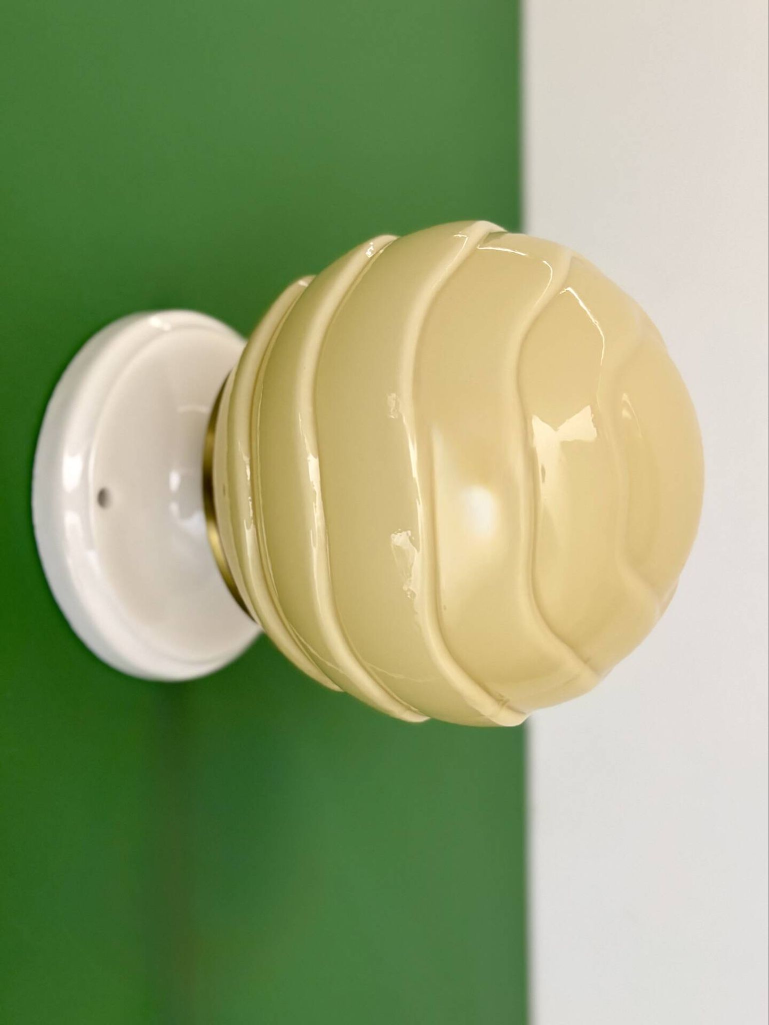 Vintage Art Deco globe wall light in pale yellow opaline.