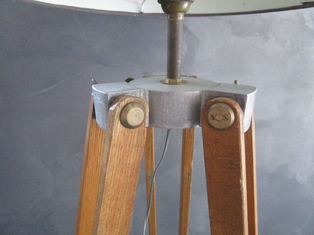 Old floor lamp on surveyor tripod