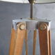 Old floor lamp on surveyor tripod