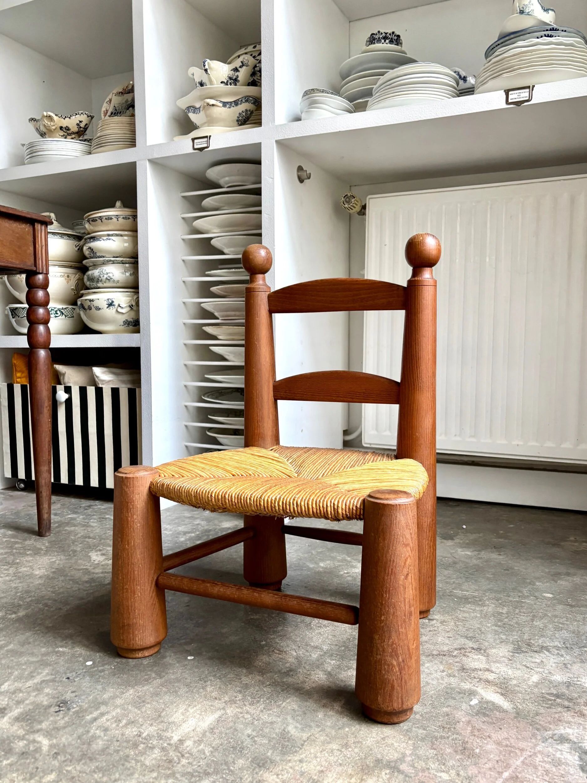 Brutalist low chair in dark wood and straw no. 3