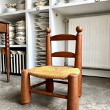 Brutalist low chair in dark wood and straw no. 3