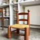 Brutalist low chair in dark wood and straw no. 3