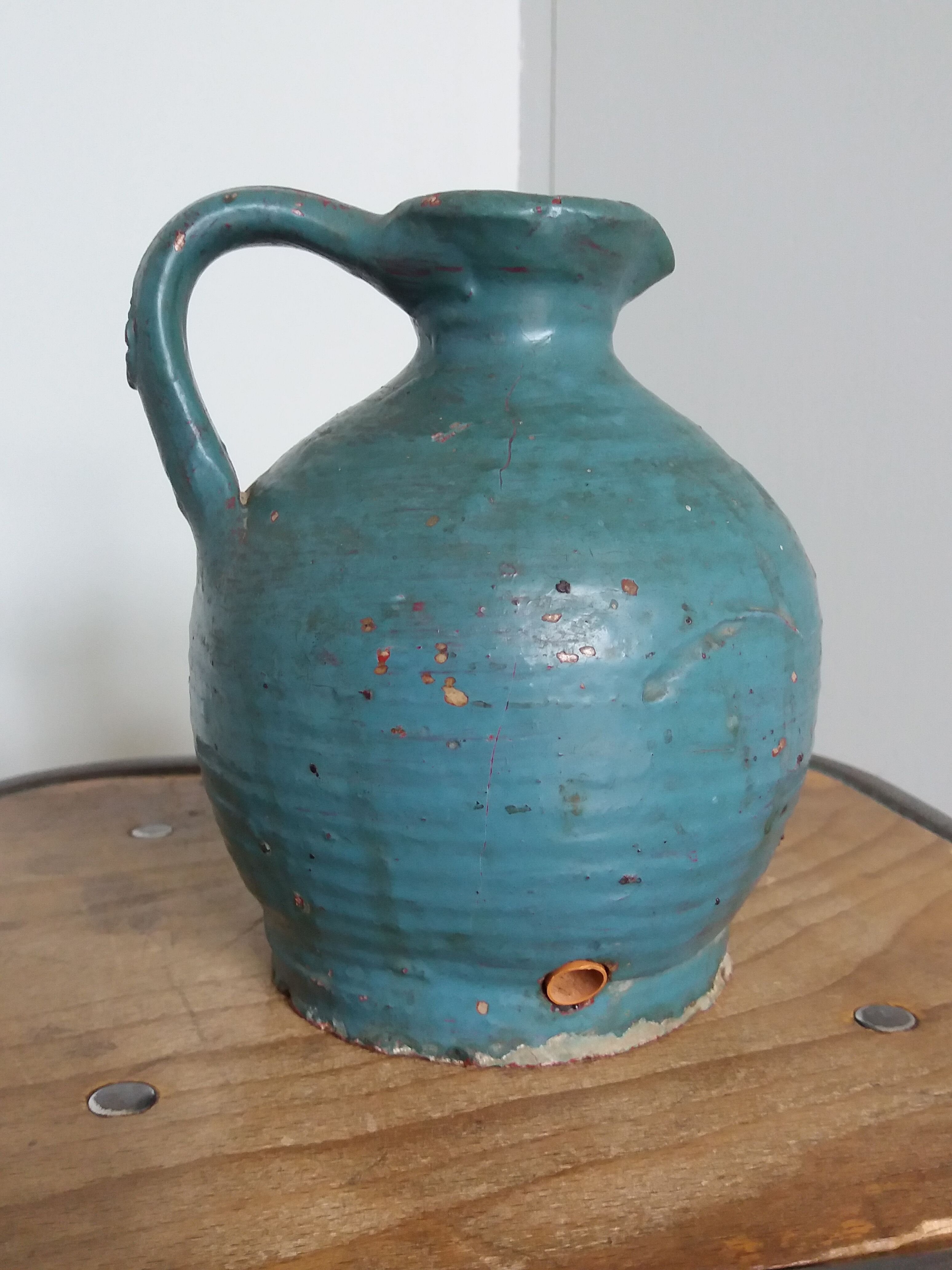 Sandstone pitcher painted in turquoise, very old pottery