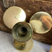 Pair of vintage brass propeller-shaped candlesticks