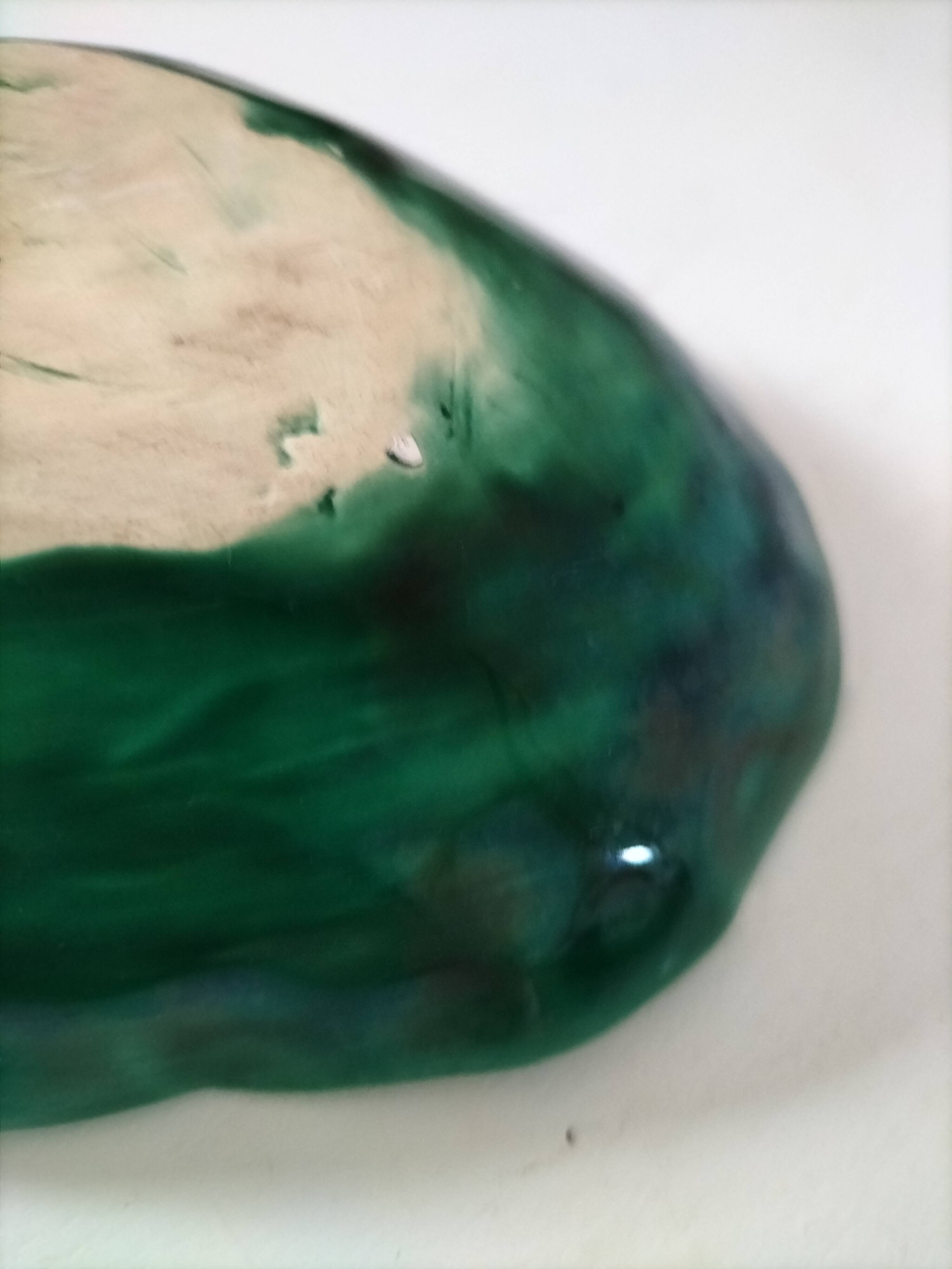 Vintage green slipware bowl in the shape of a cabbage leaf.