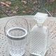 Whiskey carafe and ice bucket in transparent glass and silver-colored metal handle