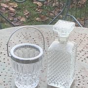 Whiskey carafe and ice bucket in transparent glass and silver-colored metal handle