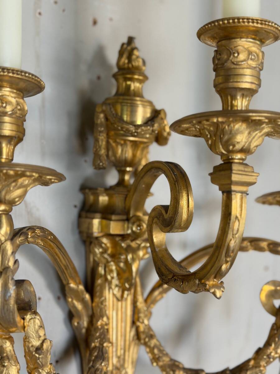 Pair of Louis XVI style wall sconces in gilded bronze, circa 1880.