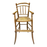 Antique bamboo caned baby chair from the early 20th century.