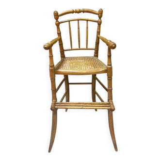 Antique bamboo caned baby chair from the early 20th century.