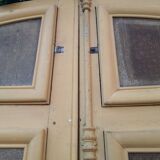 Porte d'entrée cintrée double en chêne, grilles et verre, XIXème