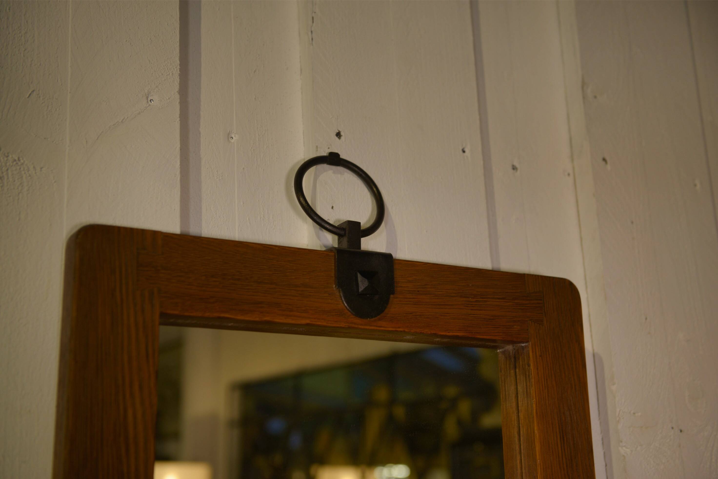 Brutalist mirror in solid oak with metal ring, 1960s.