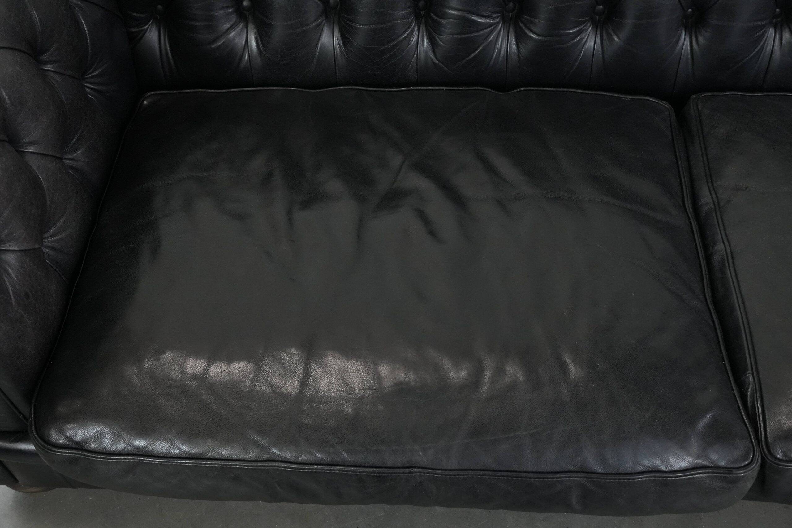 Black chesterfield 3-seater sofa made of cowhide leather in English style