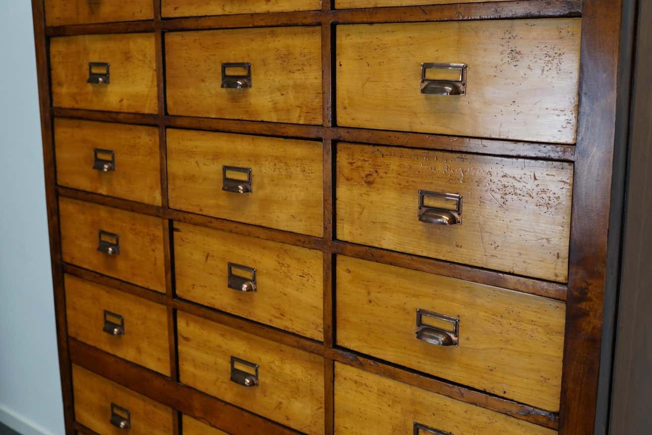 School cabinet bank of vintage Dutch drawers in mid-twentieth century pine