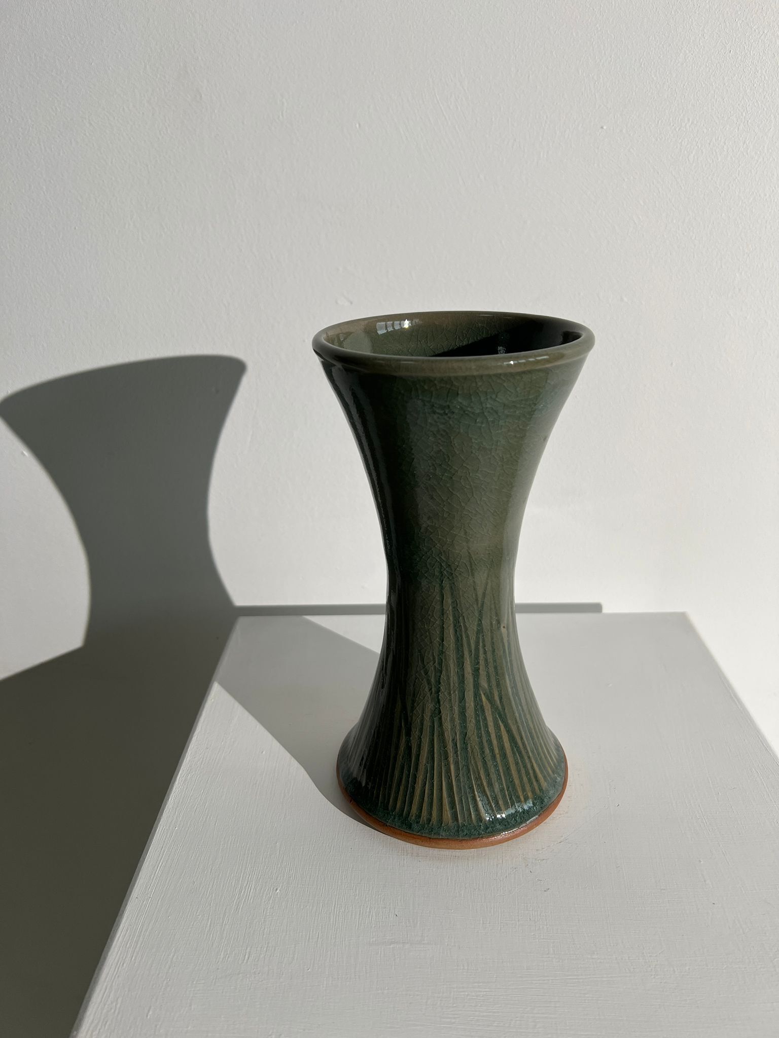 Dark green handcrafted vase with glazed ceramic grass blades