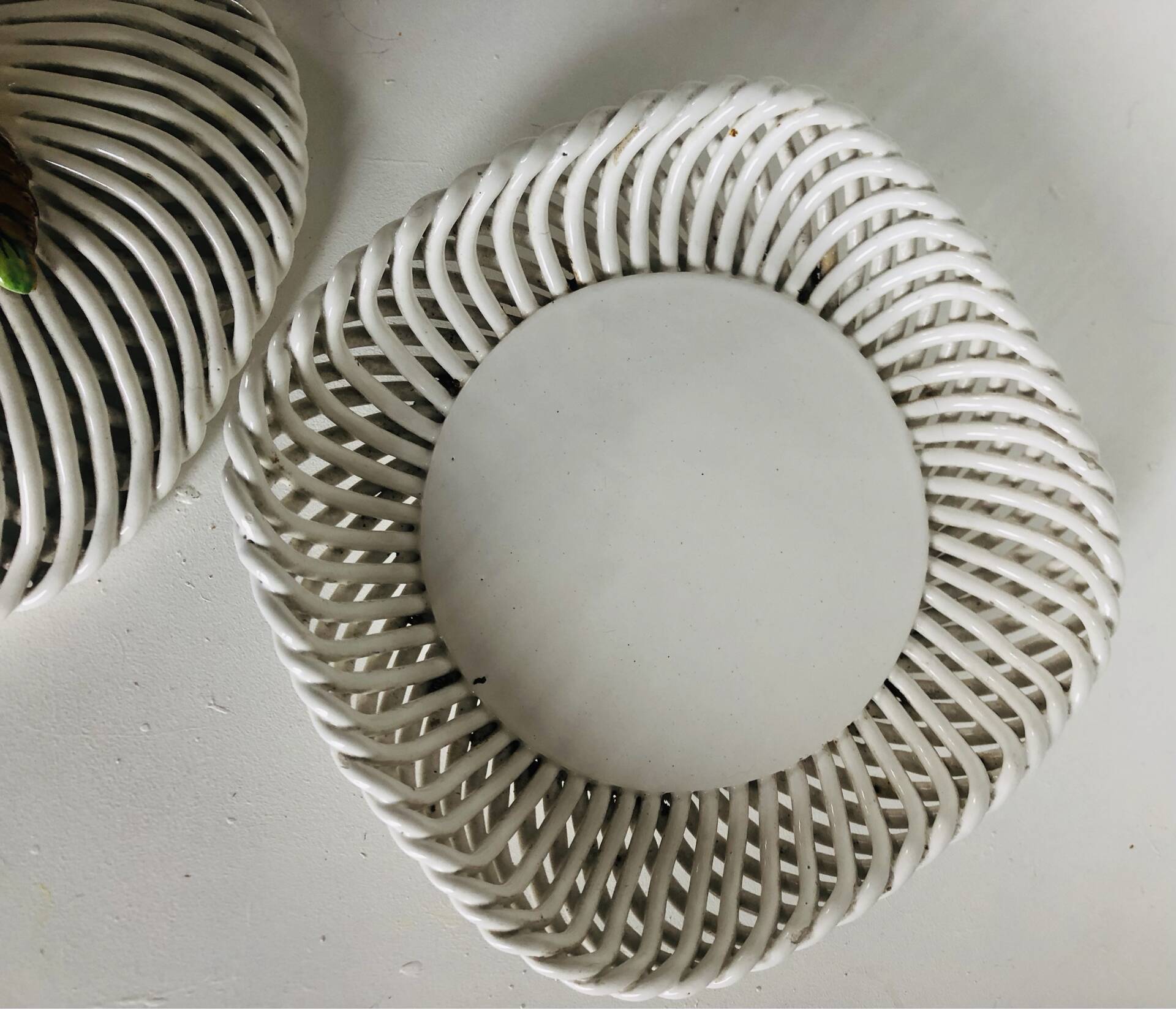 Covered basket in white woven ceramic and fruit slip.