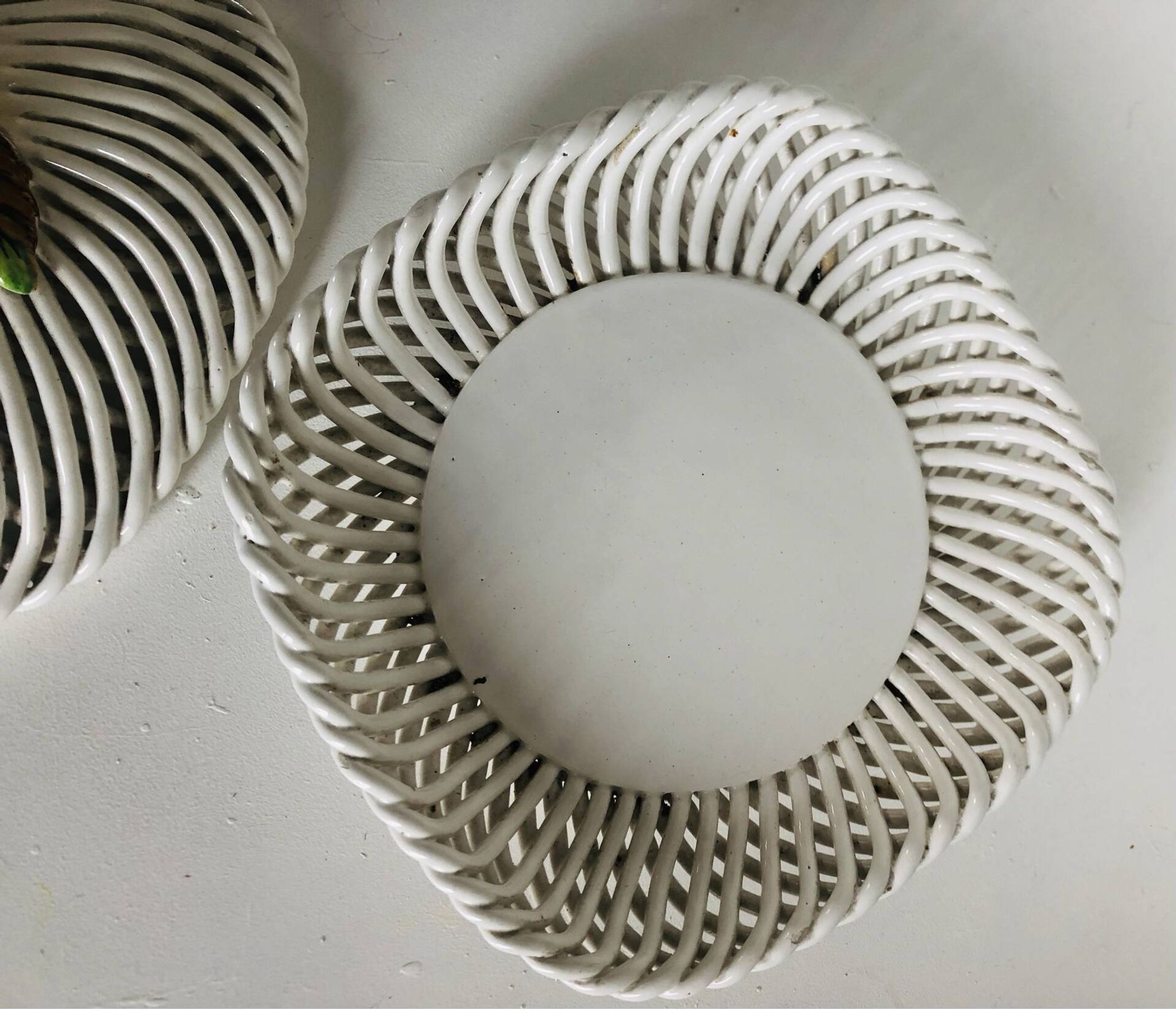 Covered basket in white woven ceramic and fruit slip.