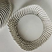 Covered basket in white woven ceramic and fruit slip.