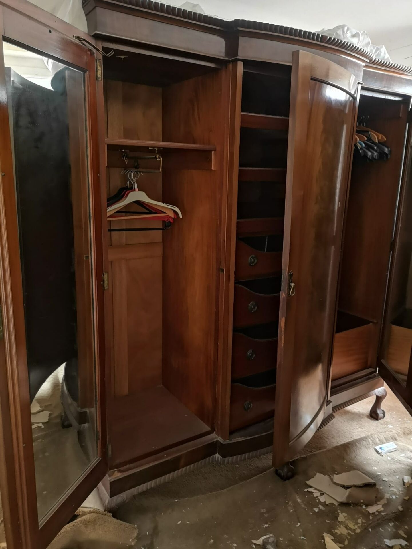 Large English-style wardrobe with a curved front and three doors.