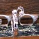Four silver-plated napkin rings in the shape of a duck/goose