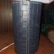 Ovoid lamp sheathed in braided blue leather and saddle stitching