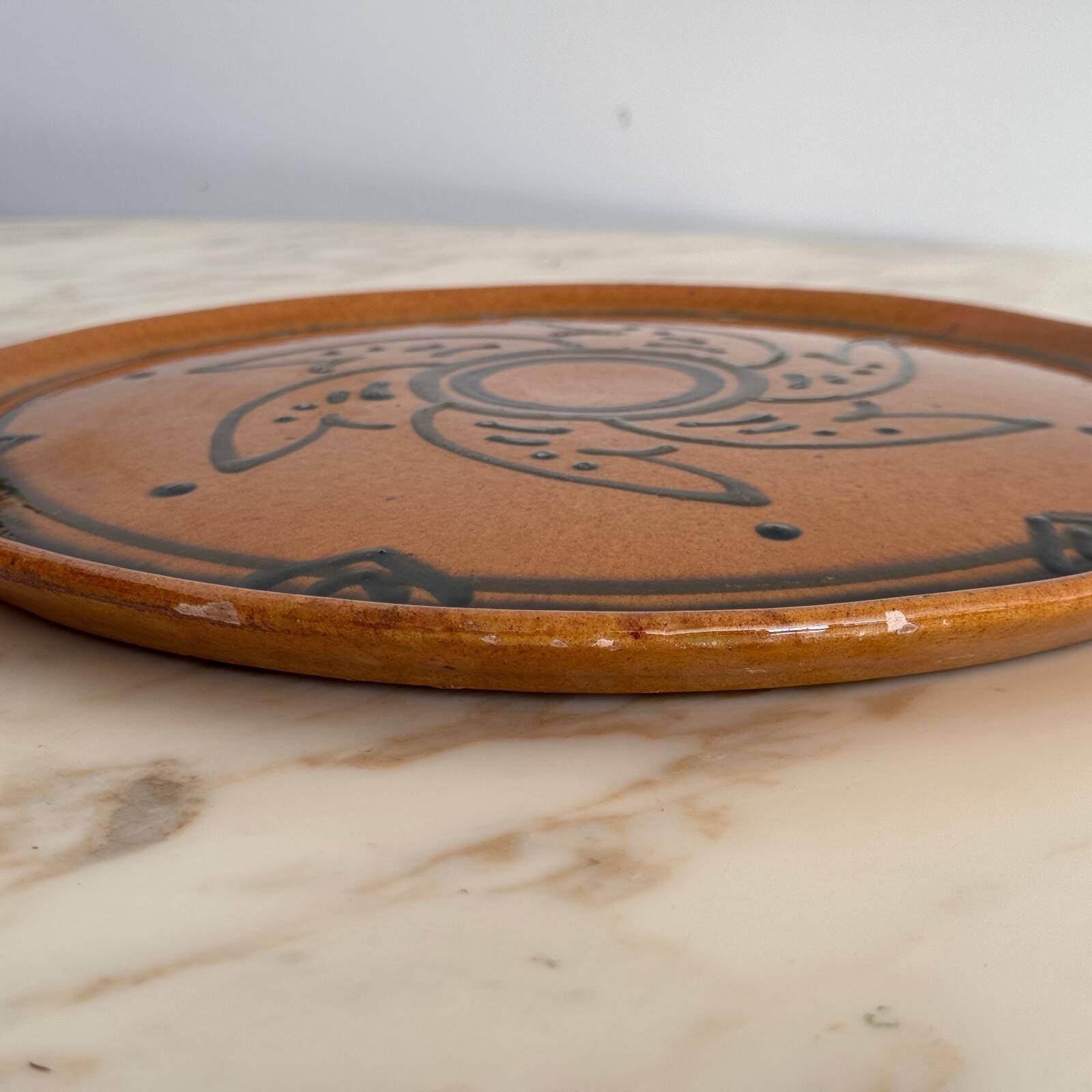 Round glazed earthenware dish by Biot, 20th century, stylized decoration