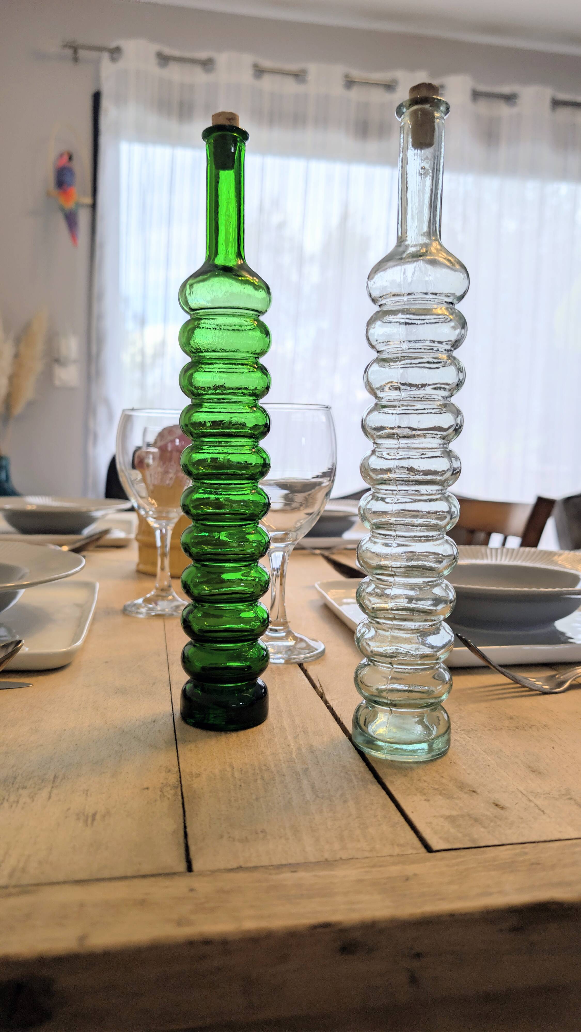 Pair of vintage ribbed blown glass bottles with cork stoppers.