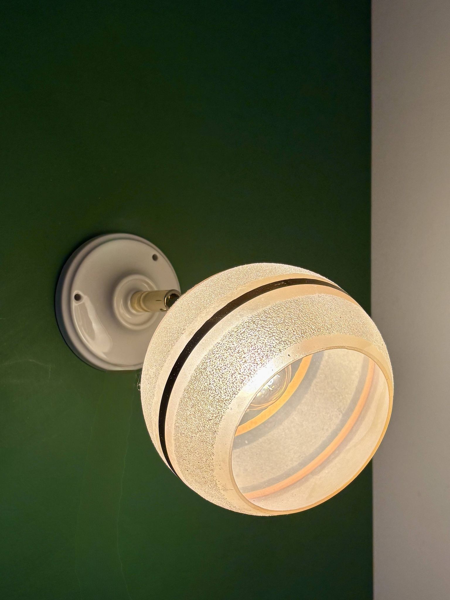 Vintage globe wall light in frosted yellow and gold glass.