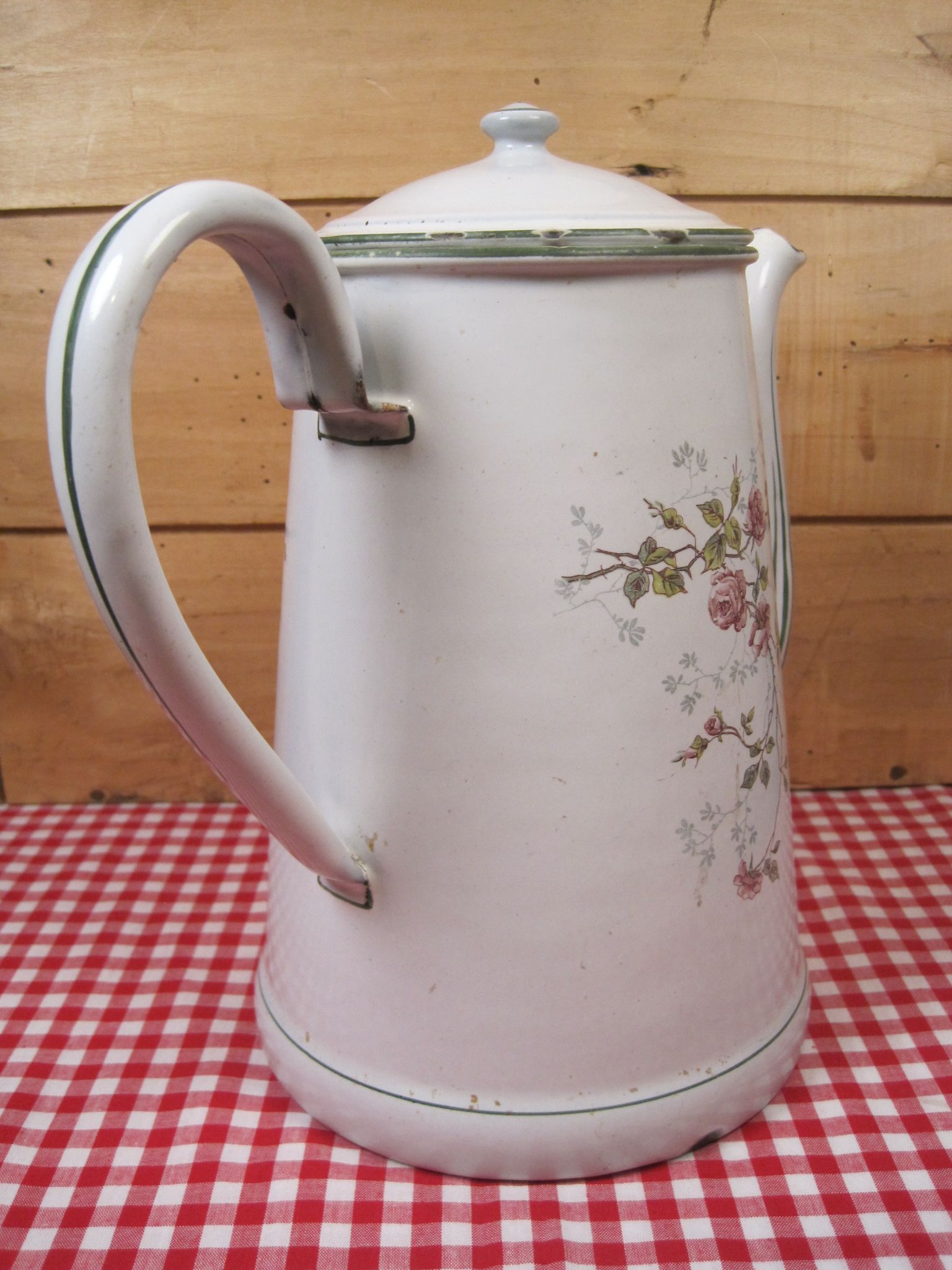 Old coffee maker in enamelled sheet metal brand bb 1900s , decoration of roses , kitchen utensils
