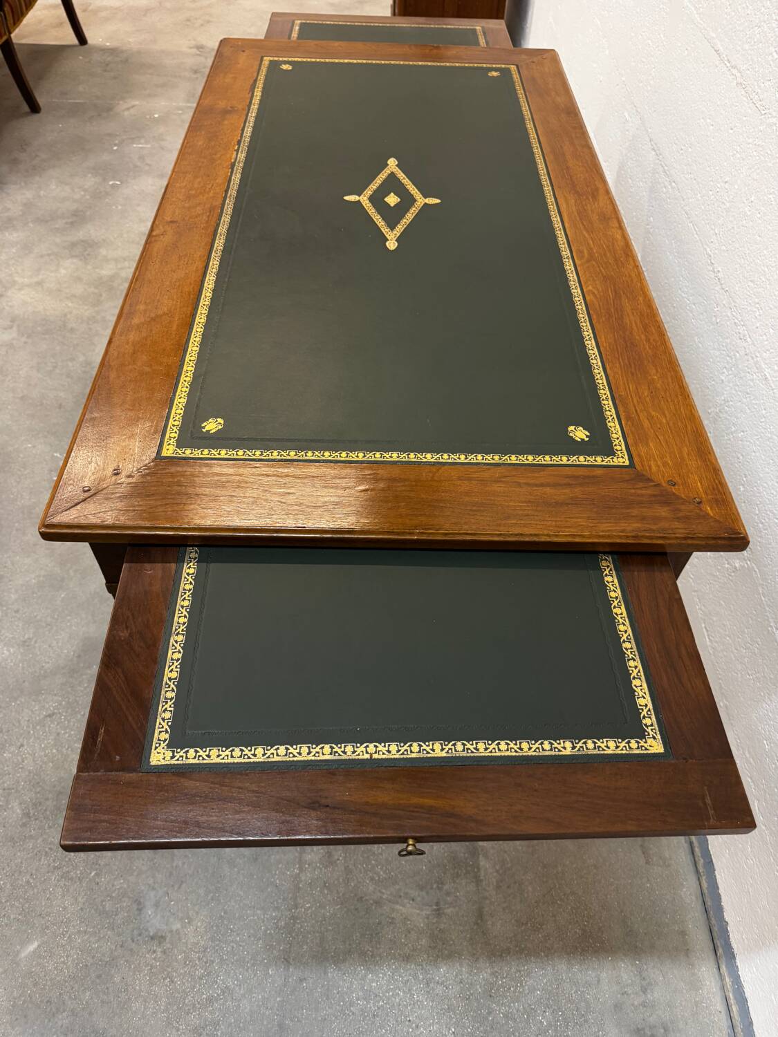 Louis XVI desk with green leather and shelves.