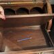 Antique solid wood secretary with a drop-down cylinder compartment.