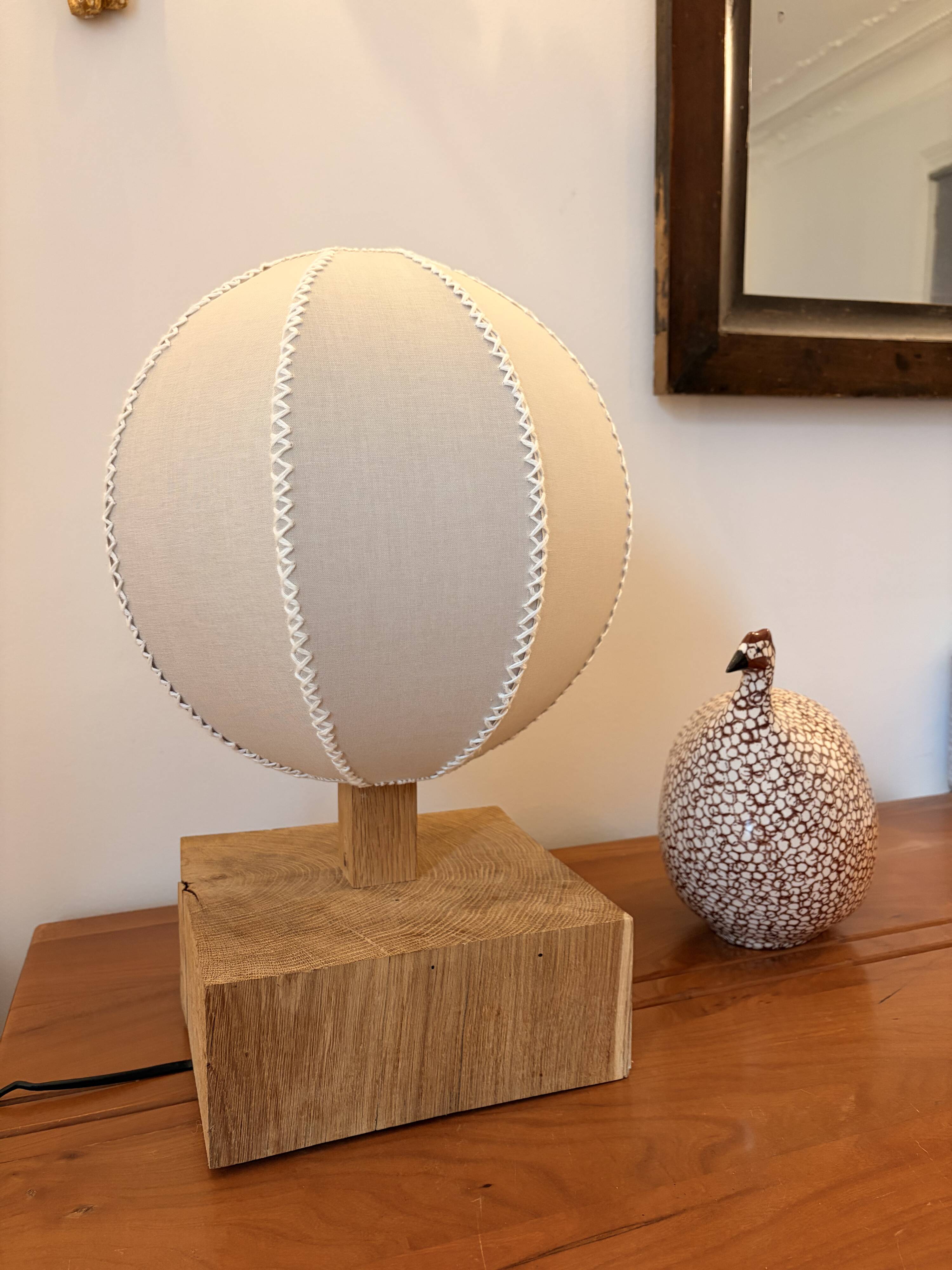 Handmade wooden ball lamp on a stand