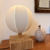 Handmade wooden ball lamp on a stand