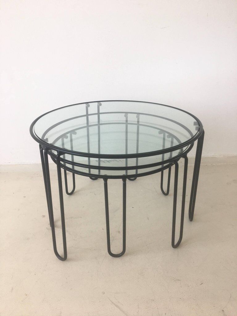 Set of three coffee tables black glass in the middle of the century with legs and metal hairpin