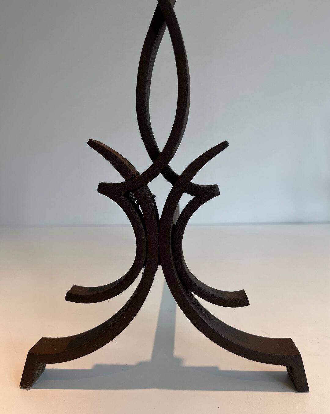 Pair of Wrought Iron Andirons with Stylised Flamboyant Uprights and Enrobed Feet