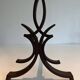 Pair of Wrought Iron Andirons with Stylised Flamboyant Uprights and Enrobed Feet